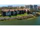 Waterfront condo building featuring well-maintained landscaping and waterfront views at 1900 Cove Ii Pl # 133, Sarasota, FL 34242