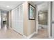 Hallway leads to bathroom with sleek floors and artwork at 1900 Cove Ii Pl # 133, Sarasota, FL 34242