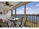 Screened lanai offers seating, a ceiling fan, and serene views of the waterfront and boats at 1900 Cove Ii Pl # 133, Sarasota, FL 34242