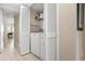 Convenient laundry room with washer and dryer units hidden behind white louvered doors at 1900 Cove Ii Pl # 133, Sarasota, FL 34242