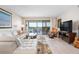 Comfortable living room with a view to the balcony and beautiful natural light at 1900 Cove Ii Pl # 133, Sarasota, FL 34242