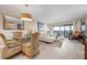 Open living space with wicker chairs, comfortable seating, and a beautiful balcony view at 1900 Cove Ii Pl # 133, Sarasota, FL 34242