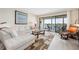 Cozy living room featuring a plush sofa, modern decor, and a private balcony overlooking the water at 1900 Cove Ii Pl # 133, Sarasota, FL 34242