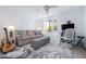 Cozy living room features a comfortable sofa, stylish decor, and plenty of natural light at 1900 Cove Ii Pl # 133, Sarasota, FL 34242