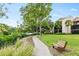 Landscaped pathway with bench seating, perfect for enjoying the natural surroundings at 1900 Cove Ii Pl # 133, Sarasota, FL 34242