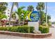 Community entrance sign amidst lush landscaping, showcasing the neighborhood's appealing curb appeal at 1900 Cove Ii Pl # 133, Sarasota, FL 34242