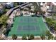 Aerial view of community tennis courts surrounded by lush landscaping at 1900 Cove Ii Pl # 133, Sarasota, FL 34242