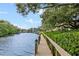 Scenic wooden walkway along the water, offering a peaceful stroll with green surroundings at 1900 Cove Ii Pl # 133, Sarasota, FL 34242