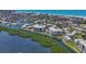Scenic aerial view of coastal real estate with waterways and lush green landscaping, showcasing a premier waterfront community at 1930 Harbourside Dr # 142, Longboat Key, FL 34228