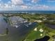 A stunning aerial view showcases the marina, golf course, and oceanfront setting at 1930 Harbourside Dr # 142, Longboat Key, FL 34228