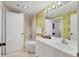 Bathroom featuring a shower-tub combo and a floral accent wall at 1930 Harbourside Dr # 142, Longboat Key, FL 34228