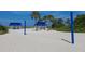 Beach volleyball court with blue posts and pavilions offers a fun recreational amenity at 1930 Harbourside Dr # 142, Longboat Key, FL 34228