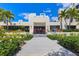 Beautifully landscaped clubhouse at Fairway Bay, featuring well-manicured greenery and inviting entrance at 1930 Harbourside Dr # 142, Longboat Key, FL 34228