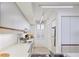 Well-lit kitchen with clean white cabinets and access to a window with natural light at 1930 Harbourside Dr # 142, Longboat Key, FL 34228