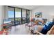 Bright living room featuring sliding glass doors that open to a balcony with expansive views at 1930 Harbourside Dr # 142, Longboat Key, FL 34228