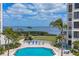 Scenic pool area overlooking the bay and lush landscaping, perfect for relaxation and enjoying the beautiful surroundings at 1930 Harbourside Dr # 142, Longboat Key, FL 34228