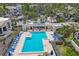 Inviting community pool with ample lounge chairs, creating a relaxing oasis in a beautiful residential setting at 1930 Harbourside Dr # 142, Longboat Key, FL 34228