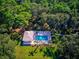 Aerial view of a home featuring a private pool, surrounded by lush greenery at 2097 Wasatch Dr, Sarasota, FL 34235