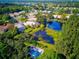 Enjoy a serene community with lush greenery, tranquil ponds, and sparkling pool, creating a relaxing environment at 2097 Wasatch Dr, Sarasota, FL 34235