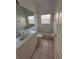 Cozy bathroom with a bathtub and a single sink vanity with an abundance of natural light at 2097 Wasatch Dr, Sarasota, FL 34235