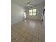 A spacious bedroom with high ceilings, tile flooring, and a large window for natural light at 2097 Wasatch Dr, Sarasota, FL 34235