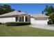Charming single-story home with a tile roof, well-manicured lawn, and an attached two-car garage at 2097 Wasatch Dr, Sarasota, FL 34235