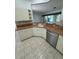 Well-lit kitchen with stainless steel dishwasher, and light-colored cabinets and countertops at 2097 Wasatch Dr, Sarasota, FL 34235