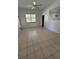 Bright living room featuring tile floors, ceiling fan, and a large window for natural light at 2097 Wasatch Dr, Sarasota, FL 34235