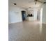 Spacious living area with tile floors leading to the kitchen at 2097 Wasatch Dr, Sarasota, FL 34235