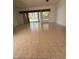 Bright living room with tile floors, a ceiling fan, and sliding glass doors to bring in natural light at 2097 Wasatch Dr, Sarasota, FL 34235