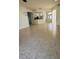 Open living area featuring tile flooring and a view into the kitchen and the front entryway at 2097 Wasatch Dr, Sarasota, FL 34235