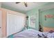 Charming bedroom featuring pink and green walls, cozy furniture, and a window with natural light at 2301 Bern Creek Loop, Sarasota, FL 34240