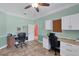 Well-lit office featuring tiled floors, a ceiling fan, and two workstation setups at 2301 Bern Creek Loop, Sarasota, FL 34240