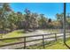 Expansive fenced pasture area with lush green grass and mature trees, great for livestock at 2301 Bern Creek Loop, Sarasota, FL 34240