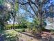 Expansive backyard featuring mature trees, lush landscaping, and ample green space at 240 Pocono E Trl, Nokomis, FL 34275