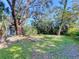 Expansive backyard with mature trees offering shade and privacy at 240 Pocono E Trl, Nokomis, FL 34275