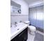Bright bathroom featuring a modern vanity, toilet, and a shower with a gray curtain at 240 Pocono E Trl, Nokomis, FL 34275
