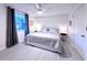 A stylish bedroom features neutral tones, hardwood floors, and a large window for natural light at 240 Pocono E Trl, Nokomis, FL 34275