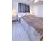 Comfortable bedroom featuring laminate floors, soft lighting, and minimalist decor at 240 Pocono E Trl, Nokomis, FL 34275