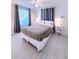 Cozy bedroom features laminate floors, soft lighting, and bedside tables at 240 Pocono E Trl, Nokomis, FL 34275