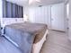 Inviting bedroom with laminate floors, soft lighting, and a large bed at 240 Pocono E Trl, Nokomis, FL 34275