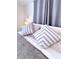 Comfortable bedroom with decorative pillows, soft lighting and neutral tones at 240 Pocono E Trl, Nokomis, FL 34275
