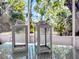 Close-up of stylish white decorative lanterns on a glass-top outdoor table at 240 Pocono E Trl, Nokomis, FL 34275