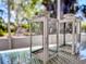 Close-up of stylish white decorative lanterns on a glass-top outdoor table at 240 Pocono E Trl, Nokomis, FL 34275