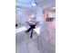 Bright dining area featuring a modern glass table and comfortable seating in a naturally lit space at 240 Pocono E Trl, Nokomis, FL 34275