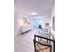 Bright dining room featuring a glass table, modern furniture, and an adjacent living area at 240 Pocono E Trl, Nokomis, FL 34275