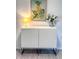 Stylish cabinet with art, lamp and flowers at 240 Pocono E Trl, Nokomis, FL 34275