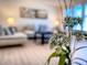 Bright living room featuring fresh flowers, modern furniture, and ample natural light at 240 Pocono E Trl, Nokomis, FL 34275