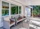 Inviting covered patio with comfortable seating and views of the surrounding landscape at 240 Pocono E Trl, Nokomis, FL 34275