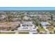 Scenic aerial showcasing this stunning yellow home with lush landscaping and community amenities nearby at 240 Spaniards Rd, Placida, FL 33946
